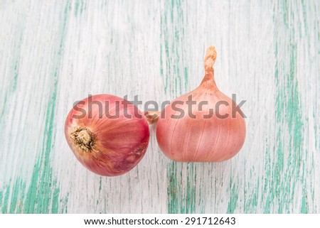 Fresh organic red onion on wooden background