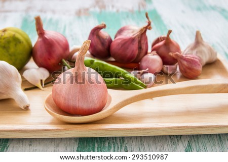 Fresh organic red onion garlic and lemon on a wooden background