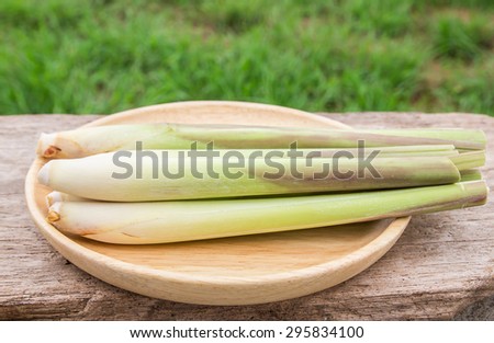 Fresh lemon grass in wooden plate on wooden table background