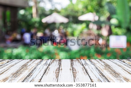 White wooden table of abstract blurred coffee shop background, for any design