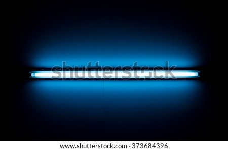 Detail of a fluorescent light tube mounted on a wall