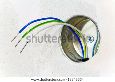 Color wires of an electric cable and terminal box, located on a gypsum board