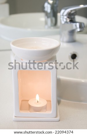 White bathroom oil burner next to basin