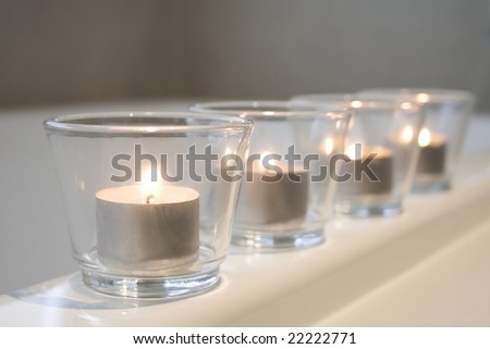 Tealight candles on the edge of a bathtub