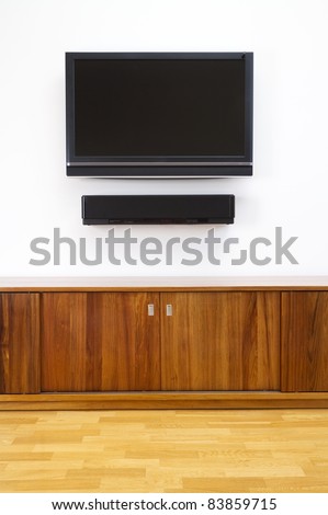 Wall mounted tv and sound system with cabinet underneath