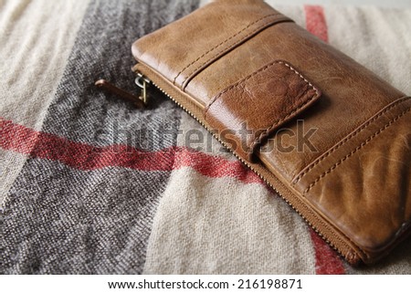 Brown leather purse on a hessian fabric scarf