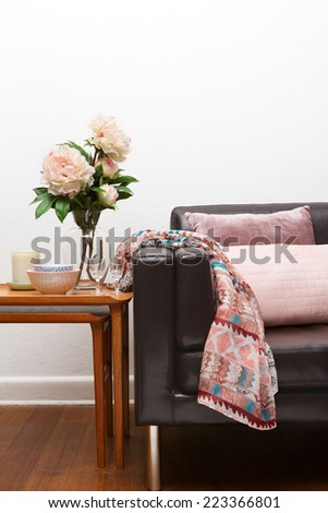Retro sofa interior with accessories flowers cushions