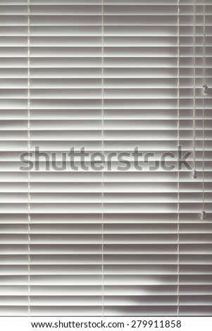 Background close up of closed wooden white venetian blinds