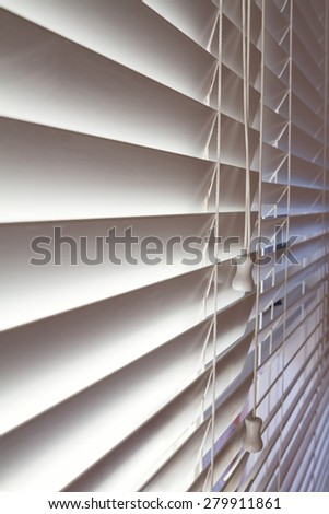 Close up background of white wooden venetian blinds in a modern home