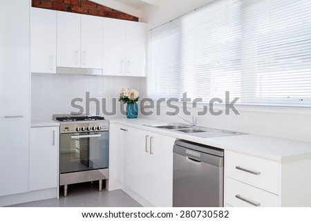 New white kitchen and appliances in a renovated villa unit