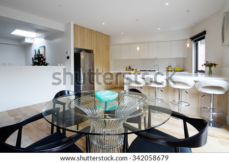 Kitchen with island bench and open plan dining area in modern australian home