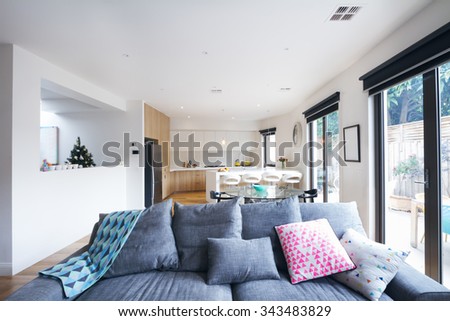 Comfortable grey sofa in open plan living room in a contemporary home
