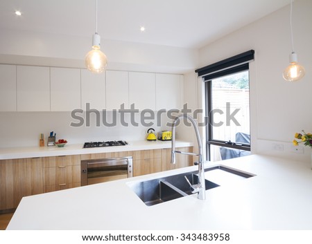 Modern kitchen with pendant lighting and sunken sink in island bench