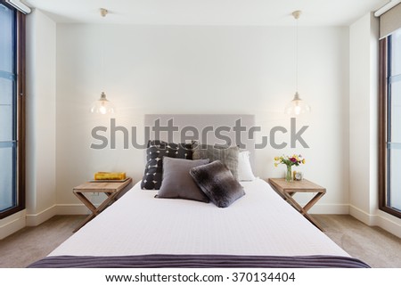 Beautiful hamptons style bedroom decor in luxury home interior with pendant lighting