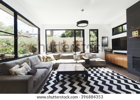 Black and white scheme living room with wood and grey tiling accents and chevron pattern floor rug