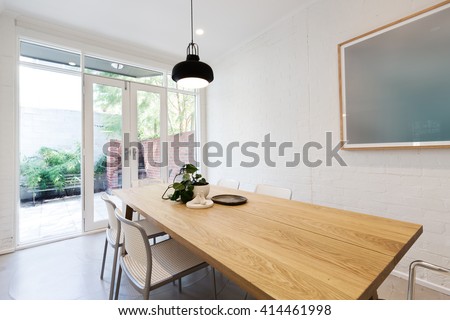 Scandi styled dining room with closed french doors in luxury apartment home