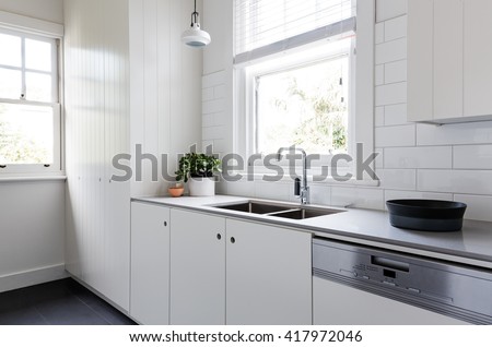 White and charcoal new renovated galley style Australian apartment kitchen