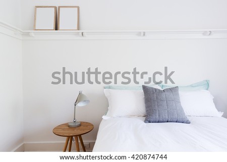 White bedroom with simple decor items in beach styled home apartment