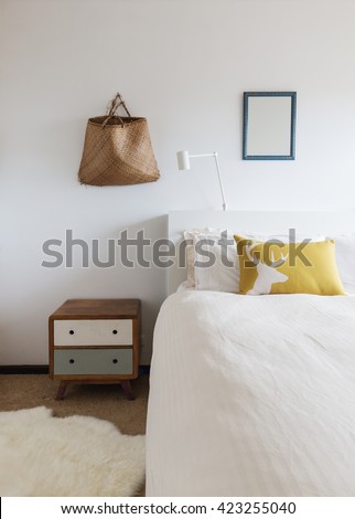 Bedroom details of retro decor side table and wall ornaments in 70s beach shack