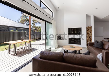 Triple sliding back glass doors from living room to outdoor deck