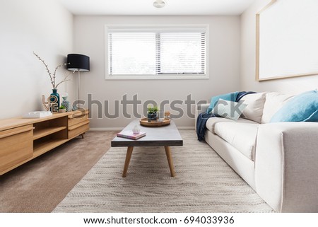 Scandi style living room interior with teal accent cushions