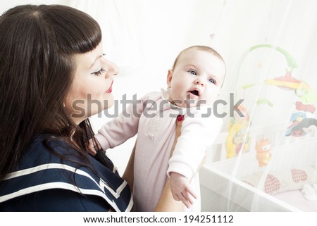 Brunette mom and cute baby girl, in rockabilly clothing, vintage.
