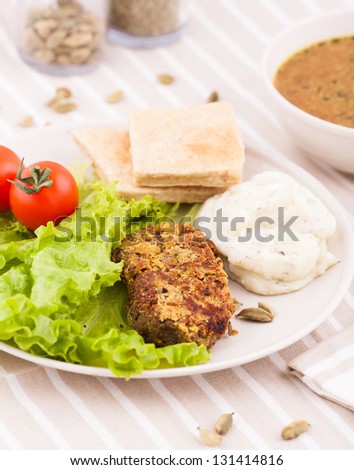a fresh garden salad with a bowl of vegetable soup