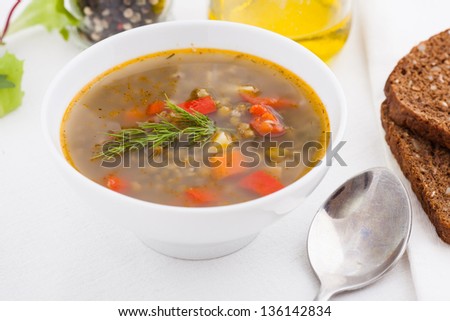 bowl of vegetable soup with brown bread