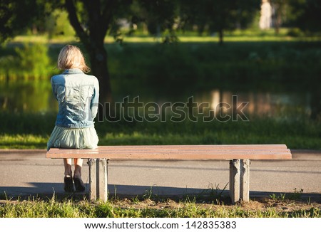 girl sitting alone on a bench