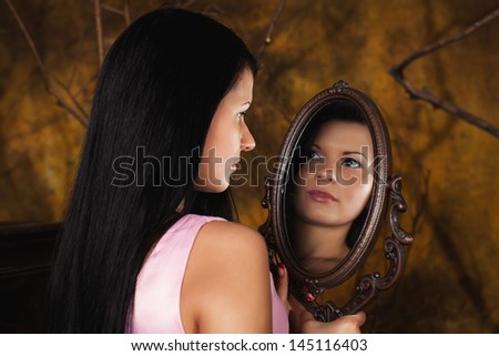 girl looks in the mirror