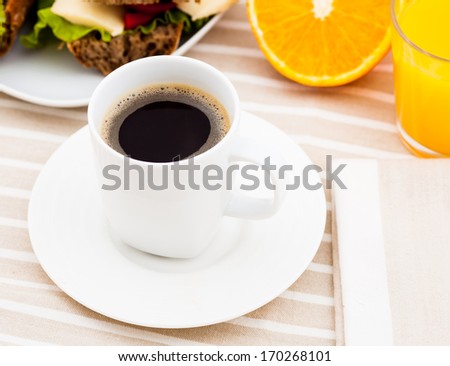 Breakfast with sandwich,  coffee and orange juice