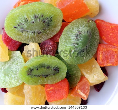 Dried fruit with kiwi, mango, pineapple on plate