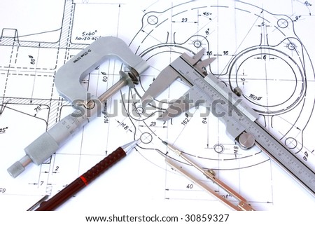 Micrometer, Caliper, Mechanical Pencil and Compass on Technical Drawing.