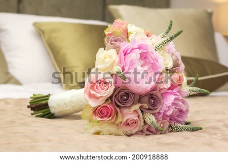 Wedding bouquet for bride on the bed
