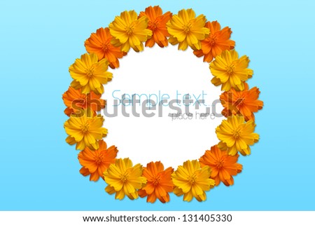 Orange and yellow flowers create a circle frame on blue background