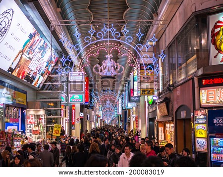 OSAKA, JAPAN - NOVEMBER 30: Tourists at Dotonbori walking street in the night of November 30, 2012 in Osaka, Japan. Dotonbori is one of the principal tourist destinations in Osaka.
