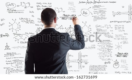 Man of science writing physics and chemistry formulas over a white background