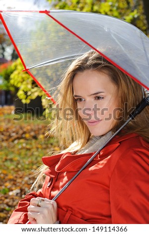 Young beautiful woman in the park in a fashion shot,  looking away and smiling - caucasian woman, autumn, fall, park, umbrella