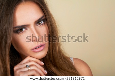 Portrait of beautiful dark hair spa woman on brown background