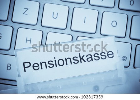 a folder for files in hanging folders in front of a computer keyboard on the subject: pension fund
