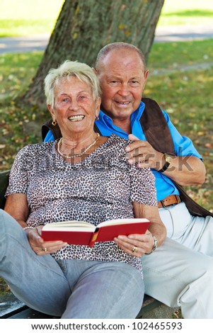 older elderly couple in love. man gives a rose.