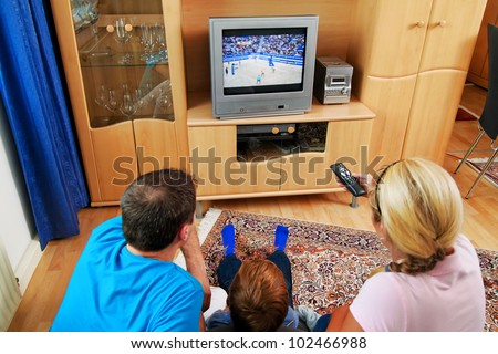 a family watching tv with tv