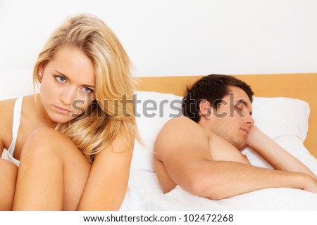 a young couple in bed has problems and crisis. divorce and separation.