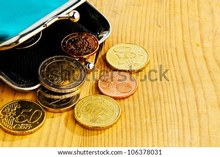 coins and an empty wallet with a few Ã?Â¢Ã¢Â?Â?Ã?Â¬. photo icon on debt and poverty