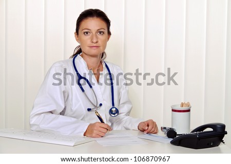 young doctor in her medical practice at the desk