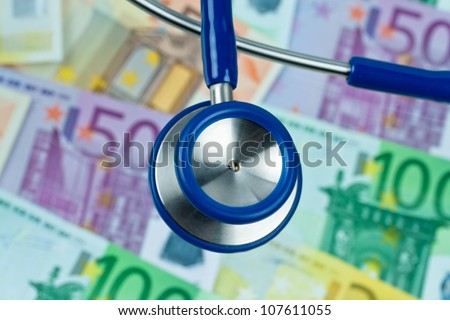 many euro bank notes with a stethoscope. health costs.