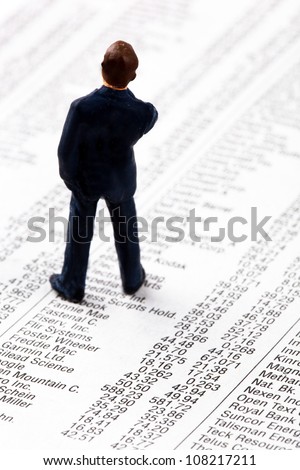 a small figure and the prices of shares in a newspaper. make money on the stock exchange. gains and losses in stock trading.