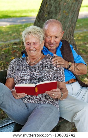 older elderly couple in love. man gives a rose.