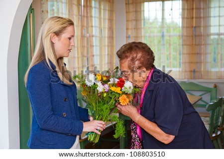 a grandson to visit his grandmother and bring flowers as a gift.