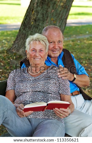 mature senior couple is in love. man handed a rose.